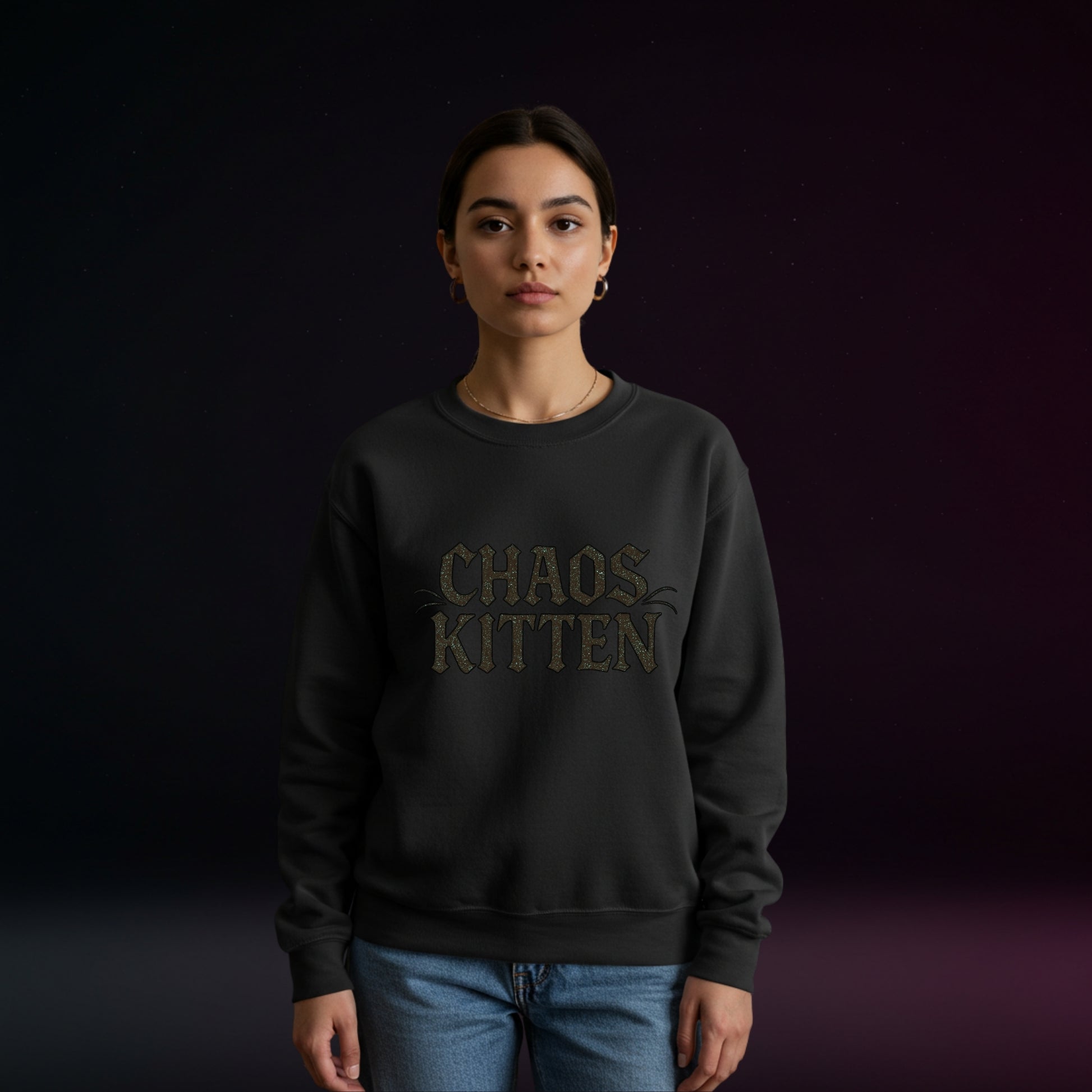 Person wearing a black sweatshirt with 'CHAOS KITTEN' text on a dark background
