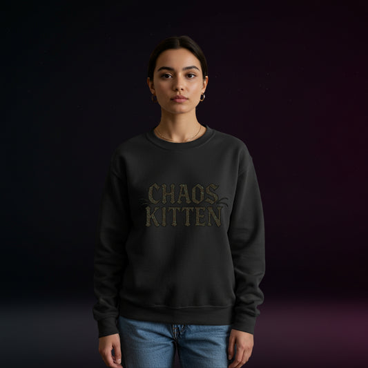 Person wearing a black sweatshirt with 'CHAOS KITTEN' text on a dark background
