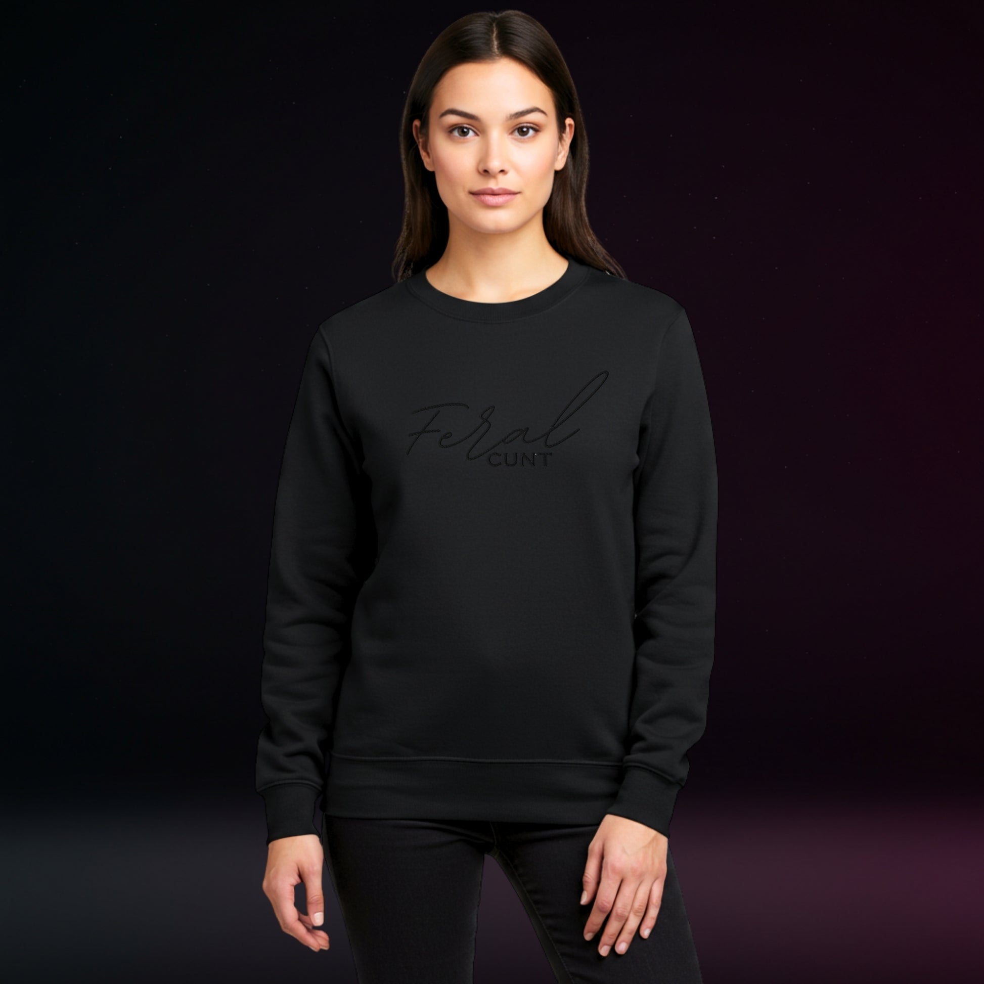 Person wearing a black sweatshirt with 'Feral C_nt' embroidery on a dark background